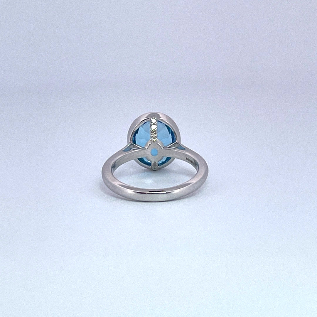 9ct white gold oval topaz with diamond set bezel